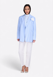 Model wearing blue flower-embellished blazer, front view